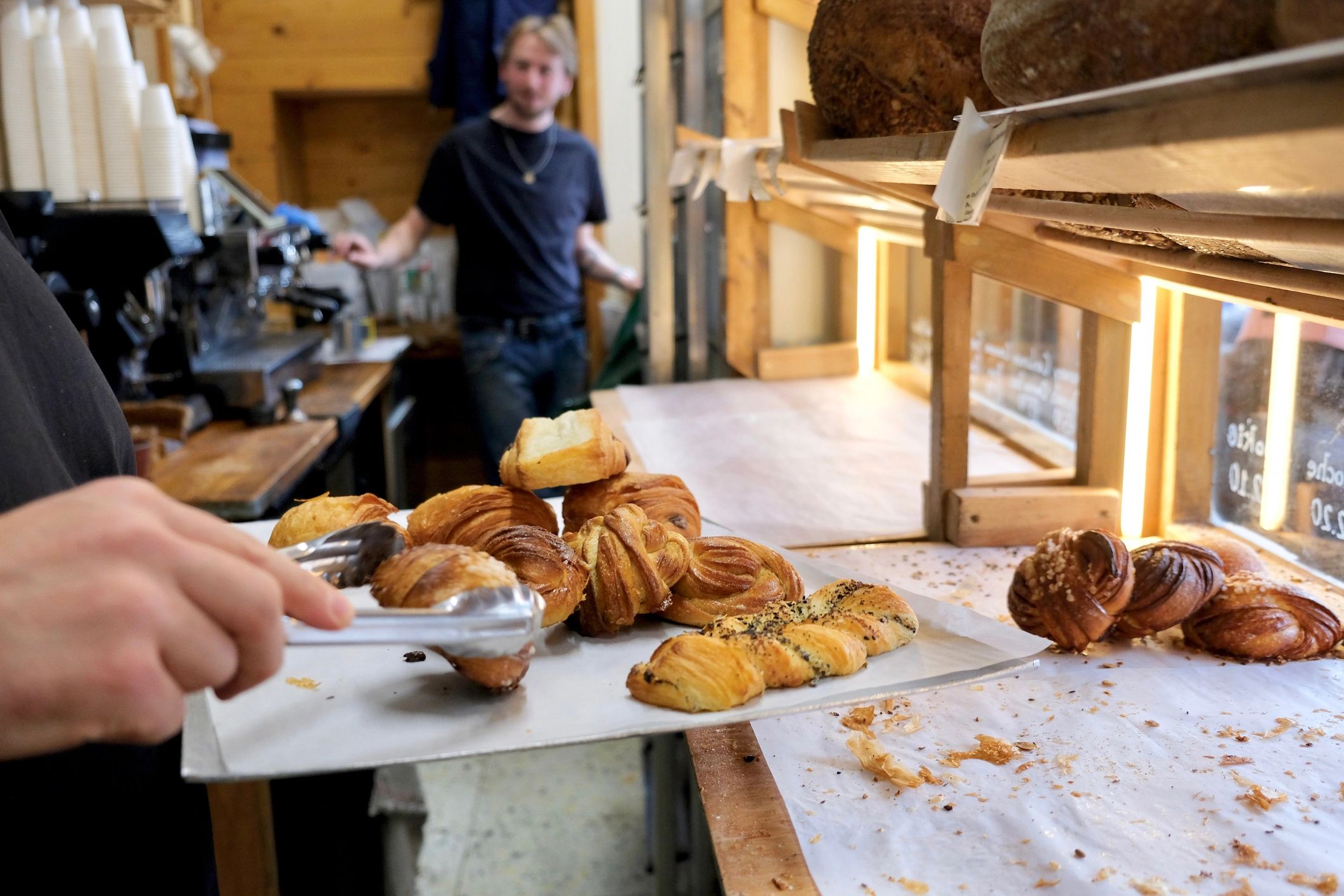 Baker crafting artisan bread by hand in the Hearts Delight Bakery kitchen